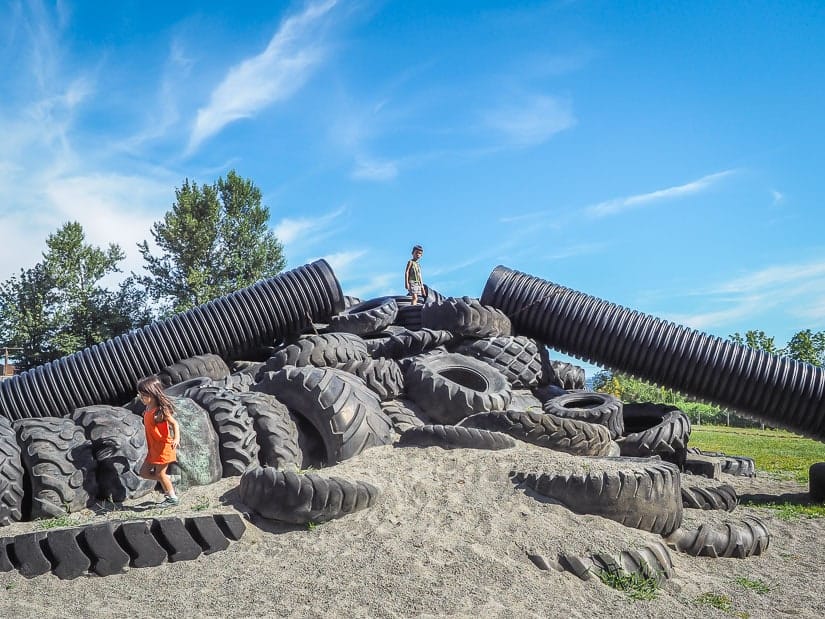 Kids playing in a pile of tractor tires