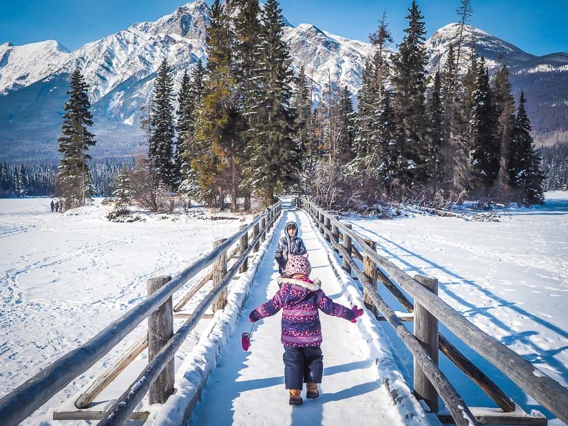 Two kids running across the bridge to Pyramid Island in Jasper