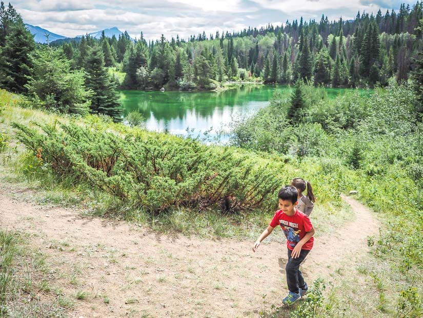 Two kids walking up a trail from second lake in the Valley of the 5 Lakes, one of the best hikes for children in jasper