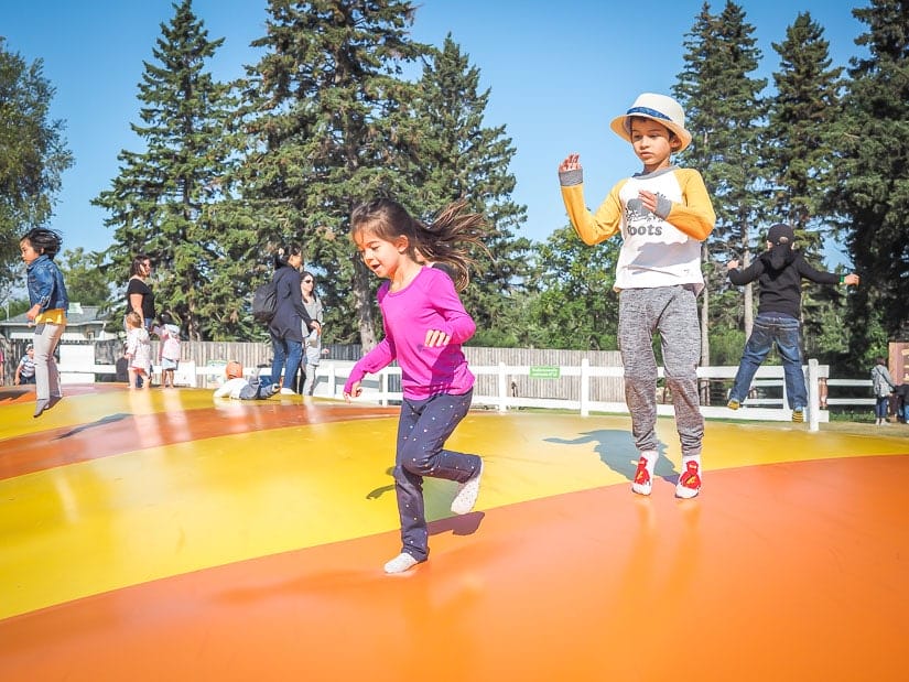 Two kids bouncing on a huge balloon at Edmonton Corn Maze