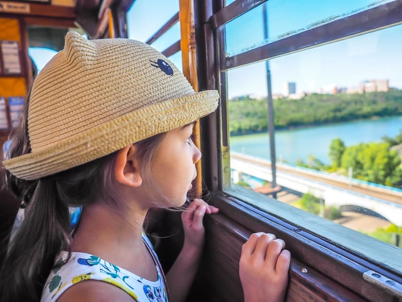 A kid looking out the window of the High Level Bridge Streetcar at the Edmonton River Valley