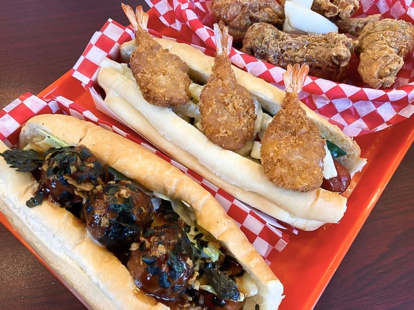 Three hot dogs covered with unusual ingredients at It'Dog & Chicken in Garneau, one of the best areas in Edmonton