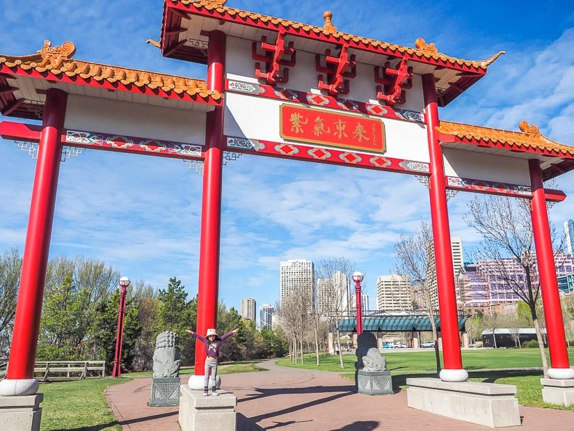 Girl standing on a Chinese Gate in Louise McKinney Park