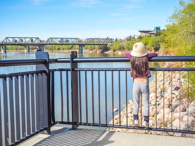 A girl looking at the Edmonton River Valley and Frederick G. Todd Lookout from Louise McKinney Park