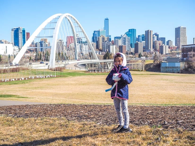 A kid standing on Queen Elizabeth Hill, with Walter Dale Bridge in the background