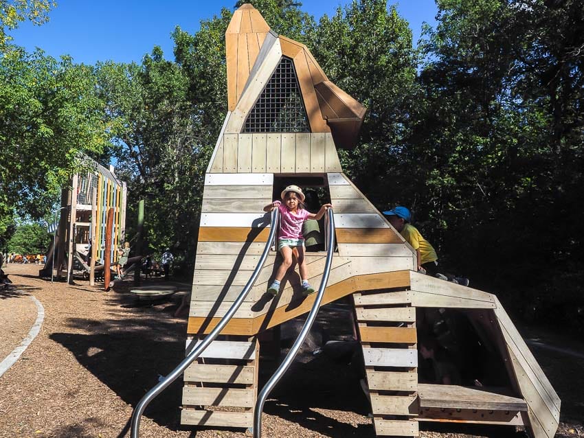 A kid standing in a coyote-shaped tower in Natural Playground, Sir Wilfred Laurier Park