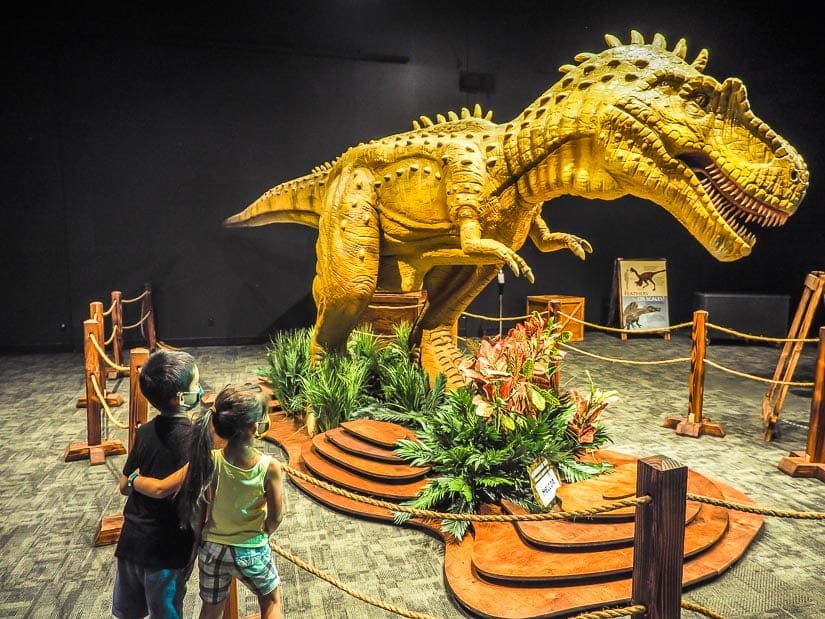 Two kids looking at a dinosaur in the Telus World of Science
