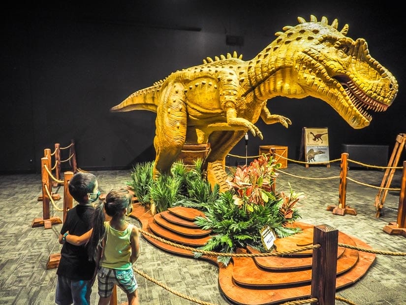 Two kids looking at a dinosaur in the Telus World of Science