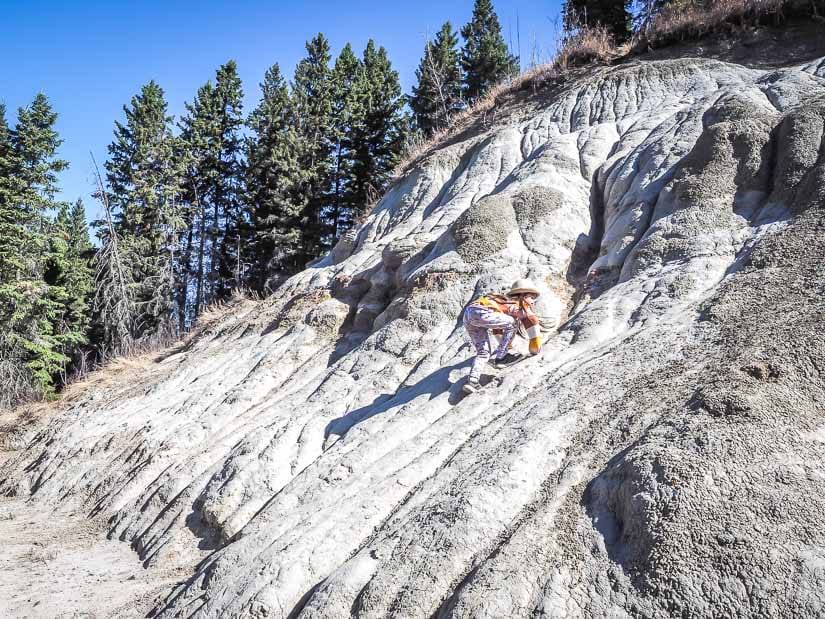 A girl climbing hoodoos in Whitemud Creek Ravine