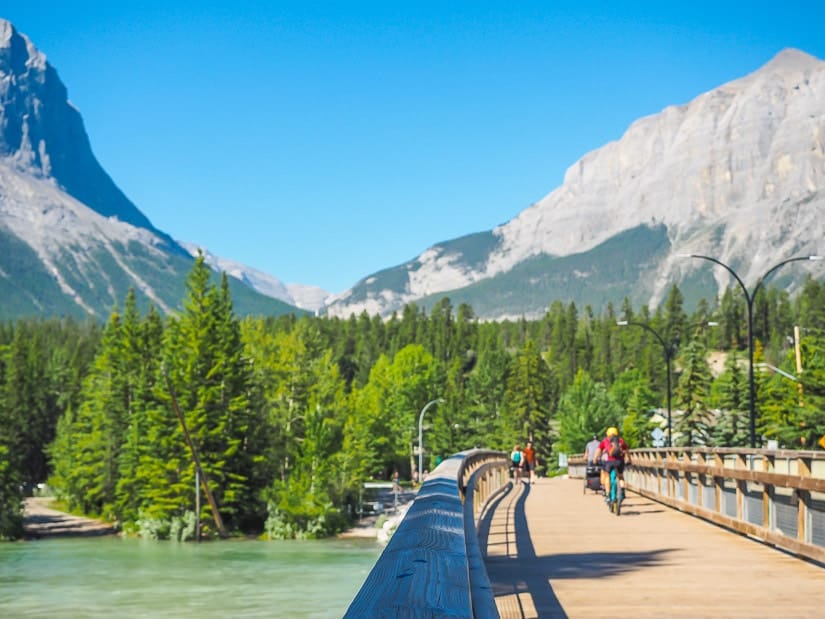 Bikes riding across Bow River Bridge at the start of the Bow River Trail