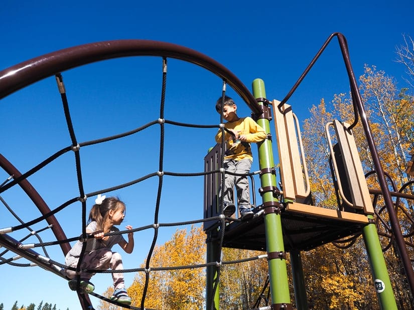 Two kids playing in playground at Elk Island National Park