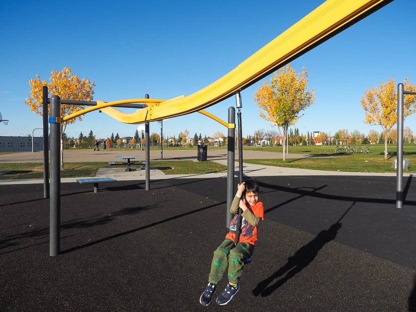 A kid riding a zipline at Florence Hallock School Playground