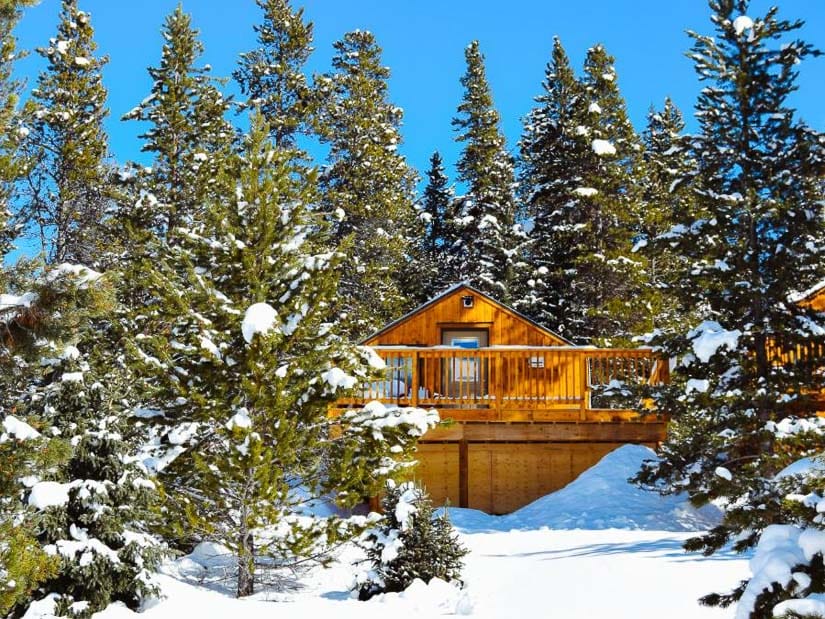 Cabin in the snowy woods at Mount Engadine Lodge in Kananaskis