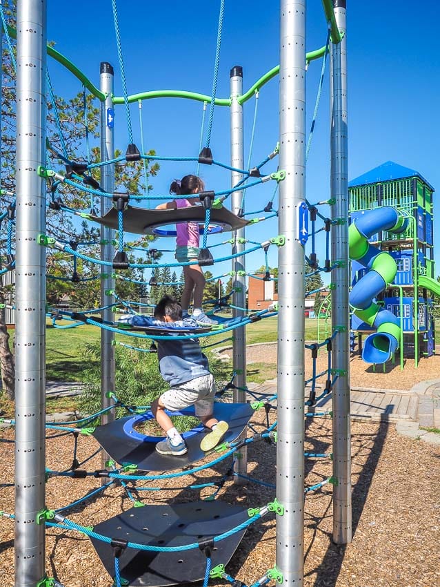 Kids playing on the Rope climbing tower at St. Boniface playground