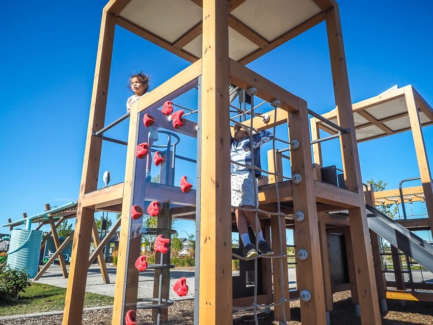 Kids playing in the playground at The Hills in Charlesworth, Edmonton
