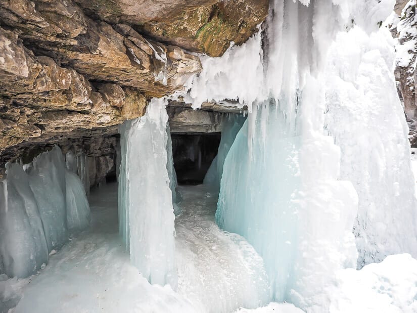 A cave behind a frozen waterfall in Maligne Canyon