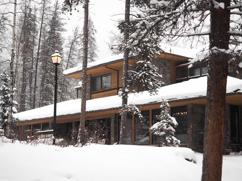 A restaurant building covered in snow at the main parking lot of Maligne Canyon in winter