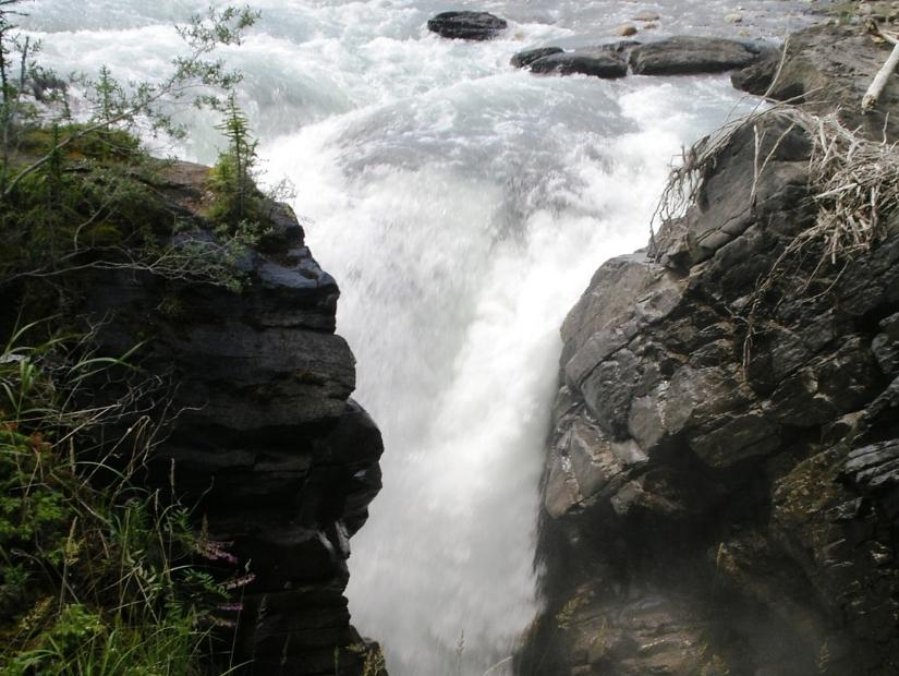 Narrow Siffleur Falls rushing through a chasm