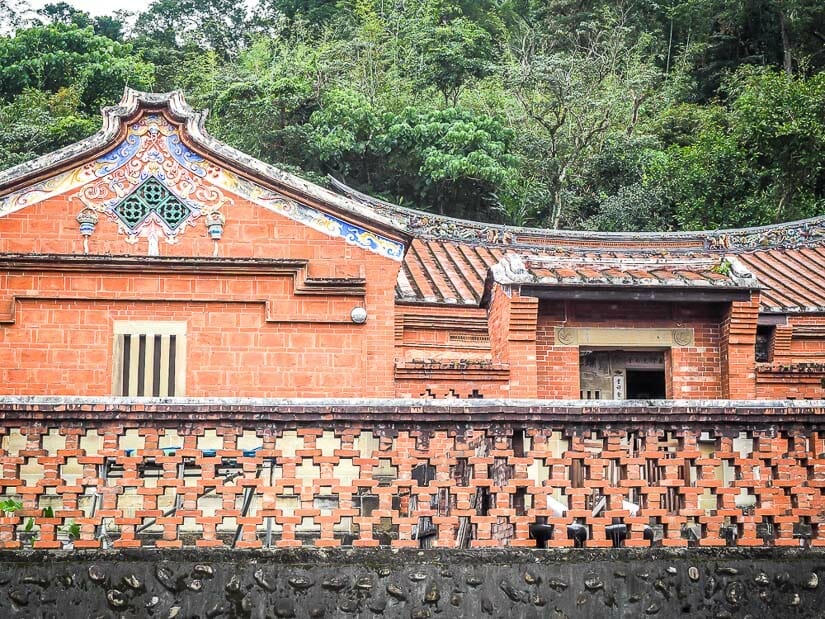 The exterior of a traditional, red brick Chinese courtyard home in Shenkeng