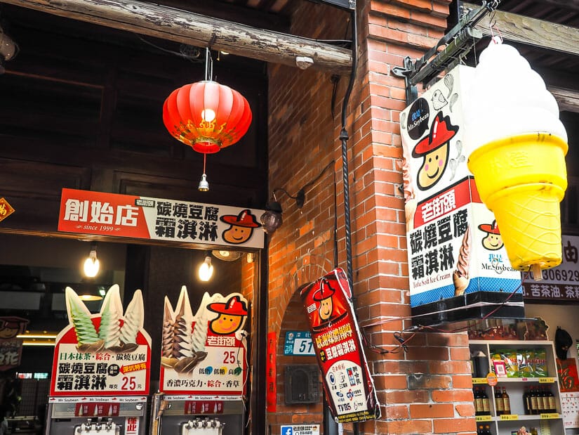 An ice cream sign and two soft serve tofu ice cream machines