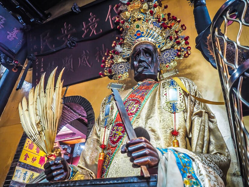 A demon statue holding a knife and fan of feathers in Dongyue Hell Temple in Tainan