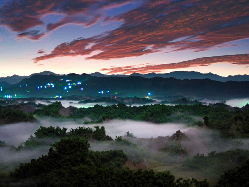 A sunset above a sea of misty hills in Tainan