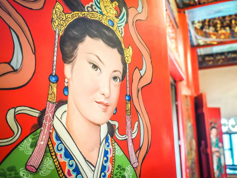 Close up of a painting of a woman on a red door in Lady Linshui's Temple