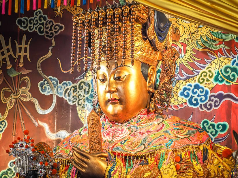A close up of a golden statue of Matsu in the Grand Mazu Temple in Tainan