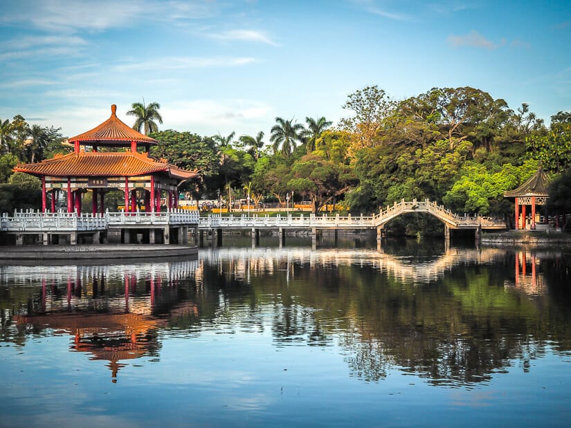 A pavilion and bridge across the pond in Tainan Park, reflecting on the water