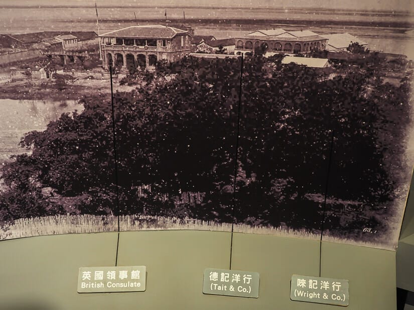 A museum display showing a black and white photograph of an aerial view of Tait & Co Merchant Warehouse in Anping, Tainan