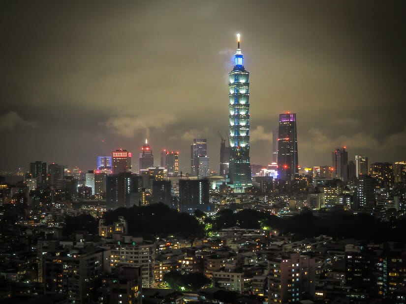 A nighttime city view of Taipei with fog around Taipei 101 taken from the hiking trail at Fuzhoushan