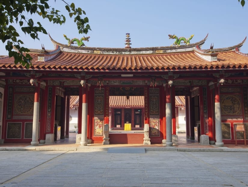 The front hall of a traditional Taiwanese Buddhist temple with some trees on the side