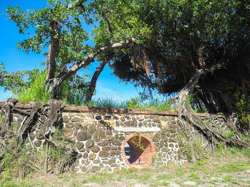 An old stone fort wall called Sican Fort with trees growing on top of it