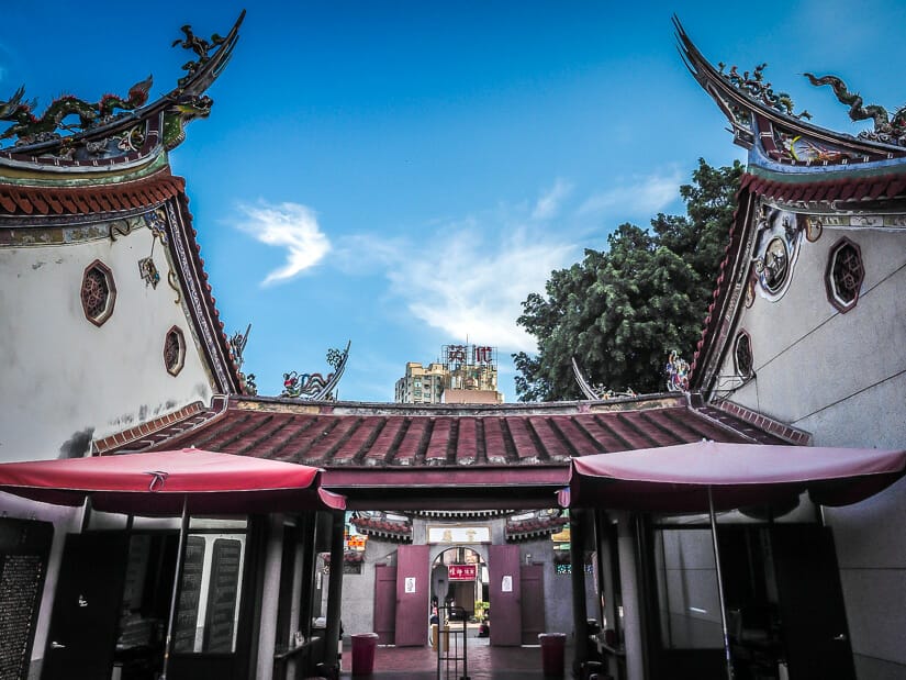 Two Taiwanese temples in Tainan that are connected by a red roof between them