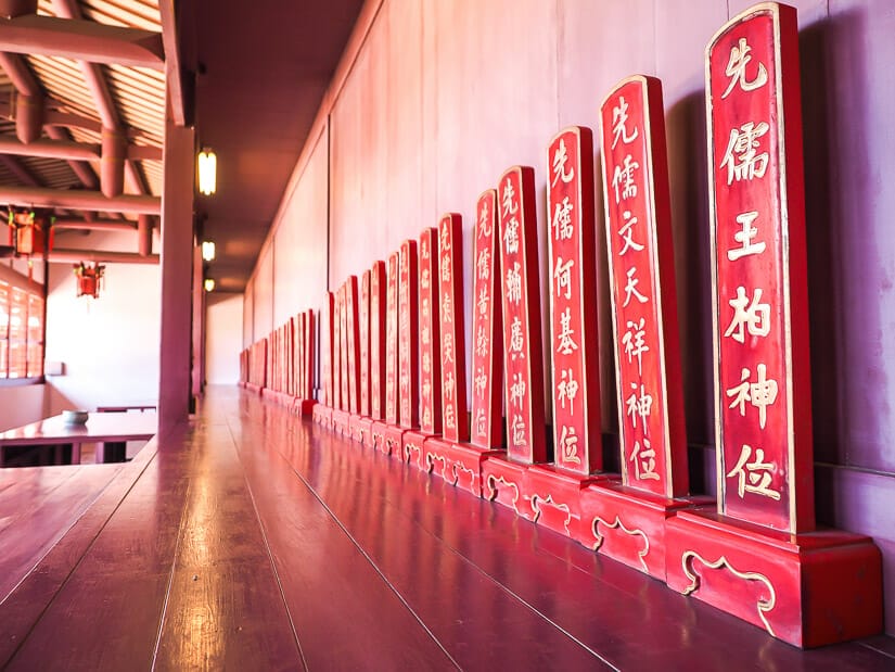 A row of red tablets with Chinese characters on them inside main hall of Tainan Confucius Temple