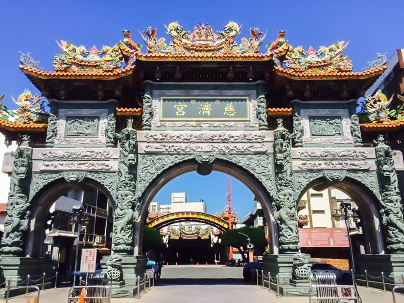 A tall, triple arched stone entrance gate to a temple