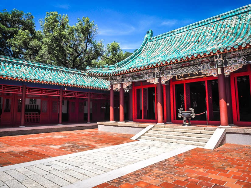 A red temple with turquoise roof inside Yanping Junwang Temple, also called Koxinga Shrine in Tainan