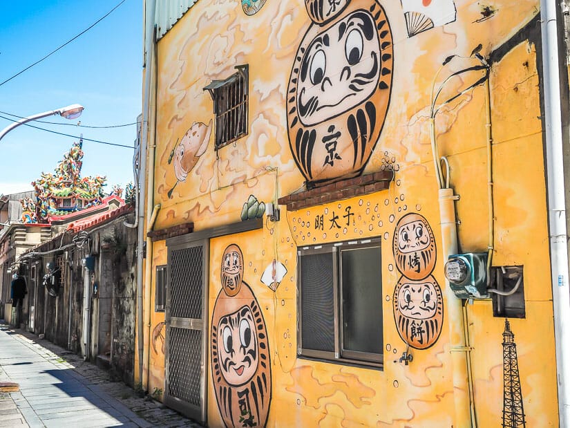 A narrow lane in Anping with a mural with Japanese gods painted on it