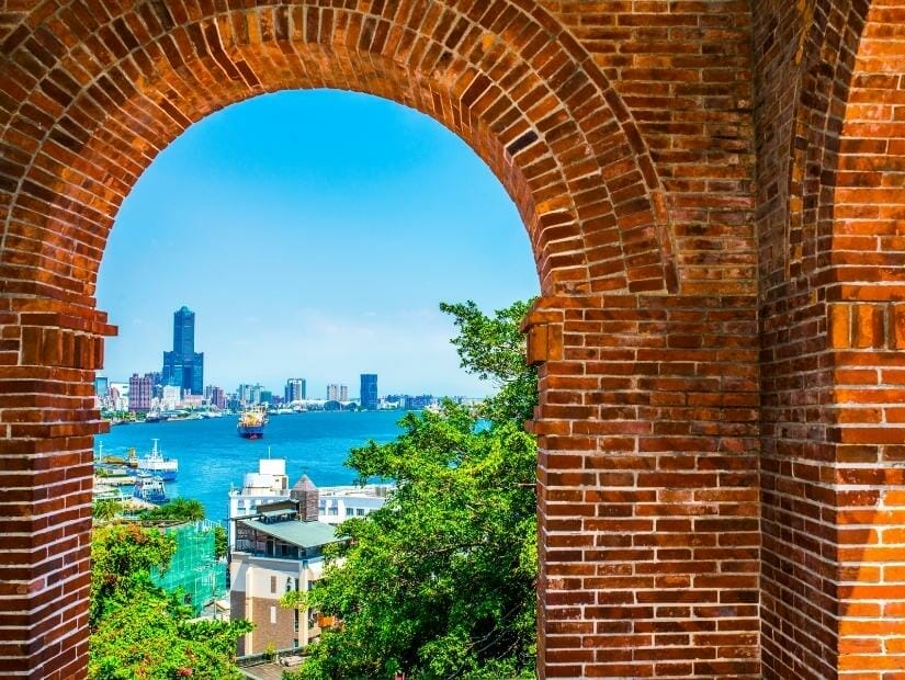 A red brick arch with a view of Kaohsiung City and Port