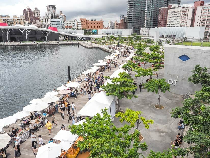 A view from above of Glory Pier in Kaohsiung with many people walking along a market