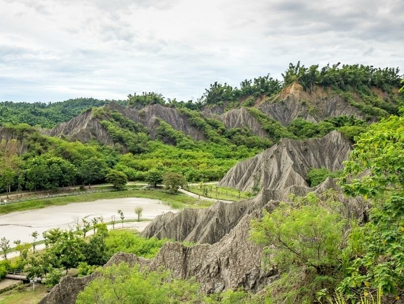 Aerial view of dry hills and a pond in Moon World, Kaohsiung