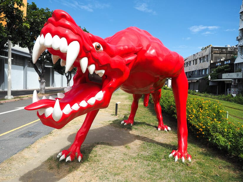 A giant red monster statue at Pier 2 Art Center