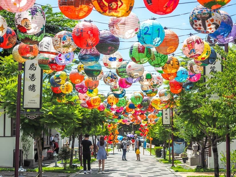 A picturesque lane in Lukang with a canopy of colorful lanterns hanging above it