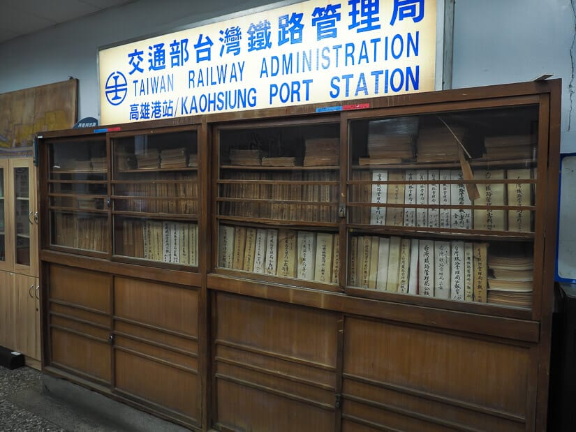A wooden shelf and sign saying Kaohsiung Port Station in Takao Railway Museum
