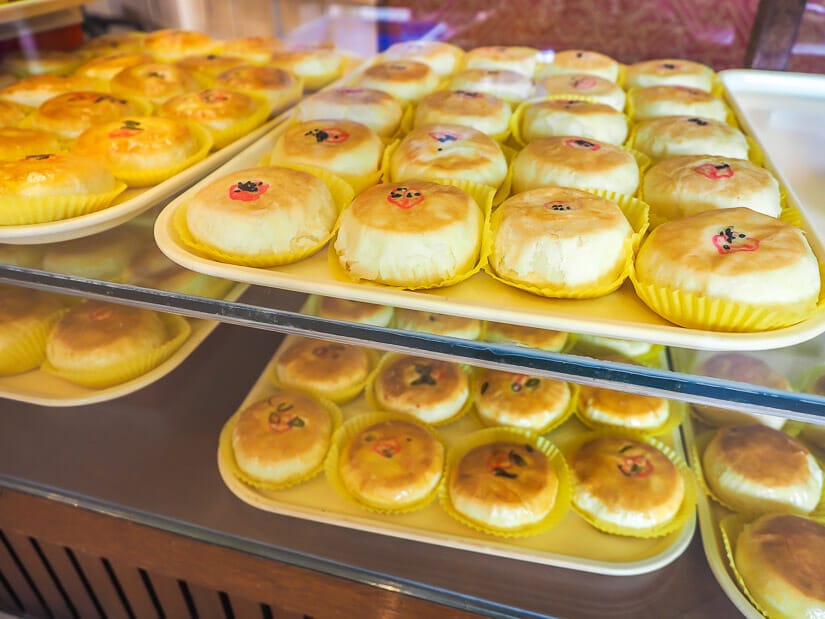 Two shelves with trays filled with traditional Taiwanese pastries at Yu Zhen Zai bakery in Lukang