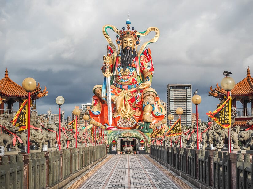 A long walkway leading to a tall, beaded statue of Yuandi on Lotus Pond in Kaohsiung