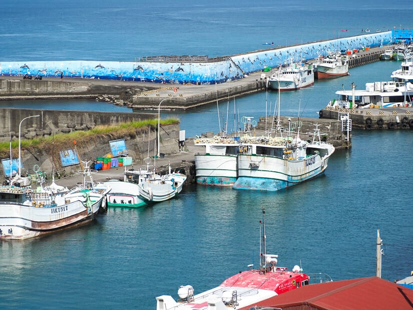Some boats docked in the main harbor of Lambai Island