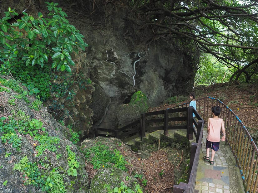 Two kids walking down a staircase into a cave at Beauty Cave