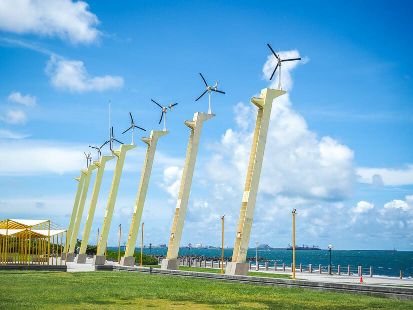 A row of turning windmills along the coast of Cijin Island