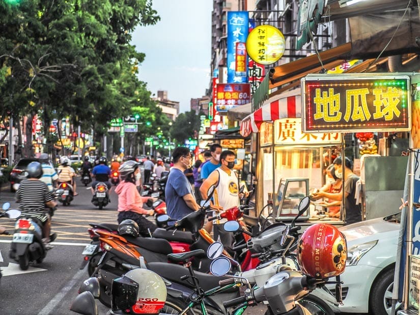 Traffic, scooters, and vendors at Guanghua Night Market